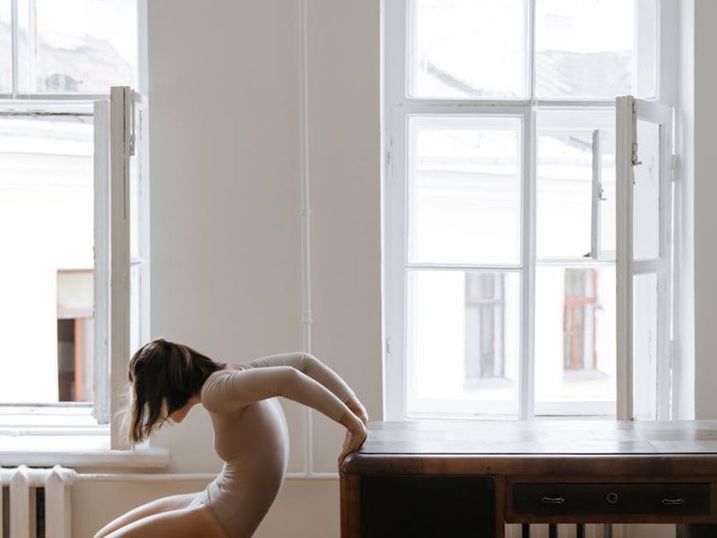 A clean, minimalist room with a yoga mat, suggesting a personal space for exercise.