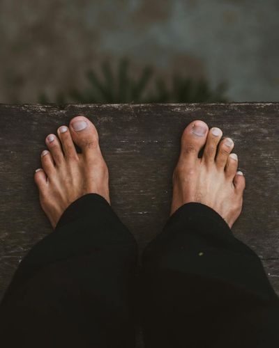 Close-up shot of feet on a mat, focusing on stability and grounding.